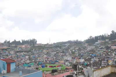 a view of a large city with buildings at Down House 19 Ooty - TEYT HOLIDAYS in Ooty
