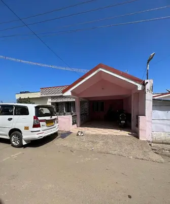 a white van parked in front of a garage at Down House 19 Ooty - TEYT HOLIDAYS in Ooty