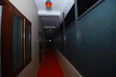 a hallway with a red carpet and a red ceiling at FAAZ Residency in Kozhikode
