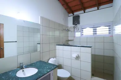a bathroom with a sink and a toilet at SaffronStays Coorg Toddy Farms, Coorg in Madikeri