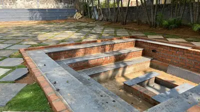 a set of brick steps in a backyard at Ayla Homes in Madikeri