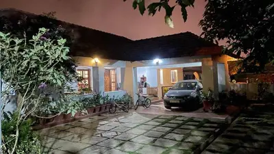 a car parked in front of a house at night at Ayla Homes in Madikeri