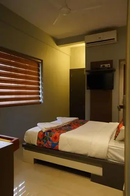 a bedroom with a bed and a window at Geetha Govindham in Guruvāyūr