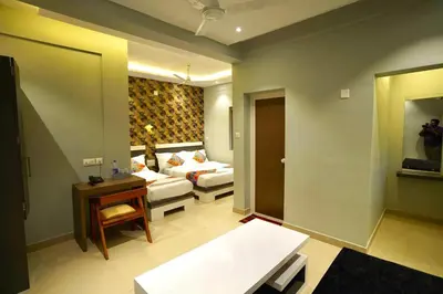 a living room with a couch and a table at Geetha Govindham in Guruvāyūr