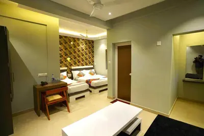 a living room with a couch and a table at Geetha Govindham in Guruvāyūr