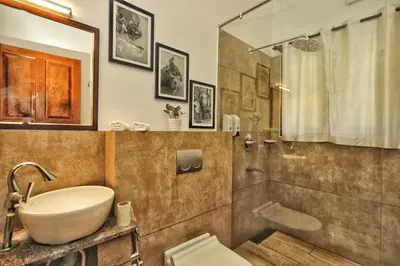 a bathroom with a sink and a shower and a toilet at Vala House in Cherai Beach