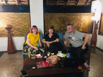 a group of three people sitting around a table at Vala House in Cherai Beach