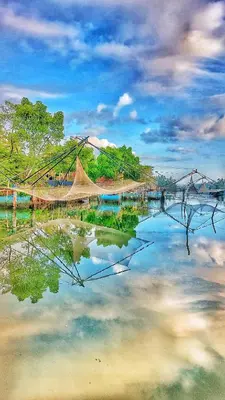 a reflection of a bridge in a body of water at Vala House in Cherai Beach