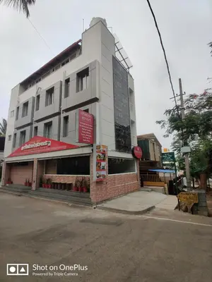 a building on the corner of a street at The Jugglers Rest in Mysore
