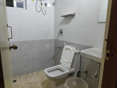 a bathroom with a toilet and a sink at Minimal Poshtel in Mysore