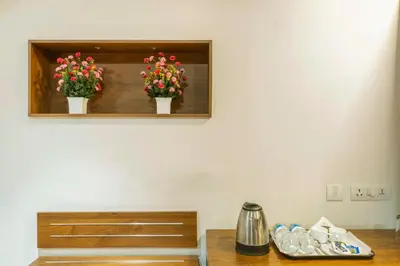 two potted flowers on a shelf in a room at KINGS CALICUT in Kozhikode
