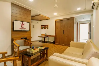 a living room with a couch and a table at KINGS CALICUT in Kozhikode
