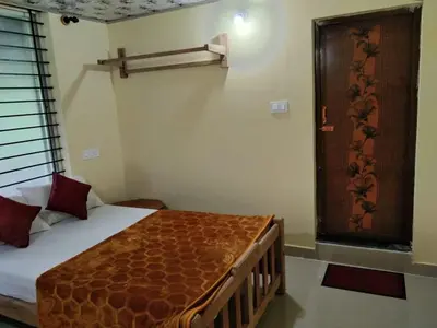 a bedroom with a bed with a wooden frame at SAMZ ESTATE Stay 3BHK in Madikeri