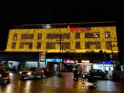 a large building with christmas lights on it at night at Marhaba Tourist Home in Kozhikode