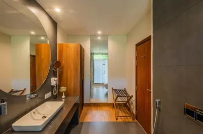 a bathroom with a sink and a mirror at Flora Vythiri Resort Wayanad in Vythiri