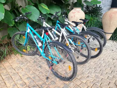 three bikes parked next to each other on a street at Flora Vythiri Resort Wayanad in Vythiri