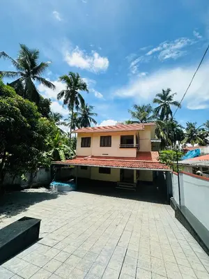 a house with a courtyard in front of it at Saaketh Holiday Home in Kozhikode