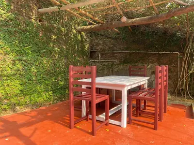 a table and two chairs sitting next to each other at Willo Stays On the beach Sea view Ocean Hues holiday home in Kannur