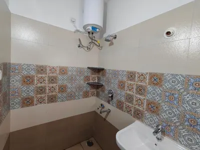 a bathroom with a sink and a tub and a toilet at Meer Stay - Premium Service Apartments in Vānivilāsa Puram