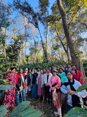 a group of people posing for a picture in a forest at Greenhouse Homestay in Siddapur
