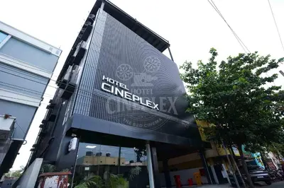 a building with a large sign on the front of it at Hotel Cineplex in Coimbatore