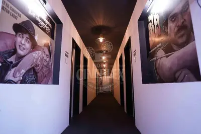 a hallway with posters on the walls of a building at Hotel Cineplex in Coimbatore