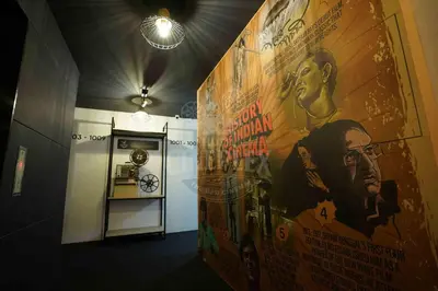 a hallway with a large movie poster on the wall at Hotel Cineplex in Coimbatore