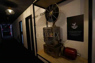 a room with a clock and a fan on a wall at Hotel Cineplex in Coimbatore