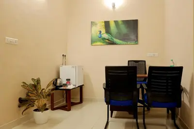 a dining room with a table and two chairs at Isha Residency in Alwaye