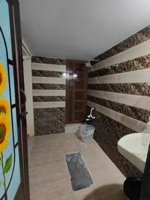a bathroom with a sink and a toilet in it at Yellow House in Mysore