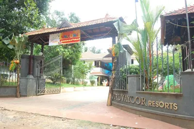 a gate with a sign in front of a house at Guruvayoor Resort in Guruvāyūr