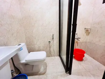 a bathroom with a shower and a toilet and a sink at Guruvayoor Resort in Guruvāyūr