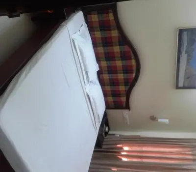a bunk bed in a room with a plaid blanket at Guruvayoor Resort in Guruvāyūr