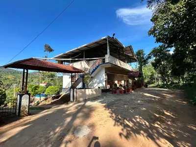 a house on the side of a dirt road at Shivalaya Homestay, Madikeri in Siddapur