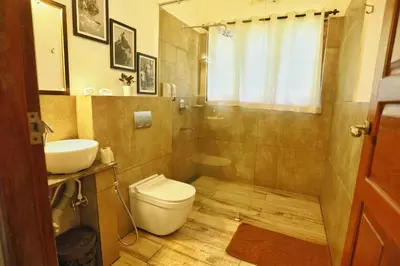 a bathroom with a toilet and a sink at Vala House - Full Villa in Pallipuram