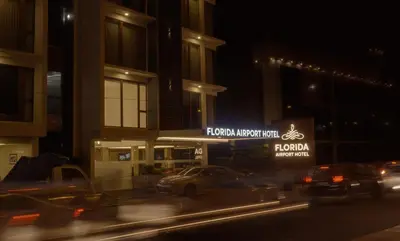 a city street at night with cars in front of a hotel at Florida Airport Hotel Kochi in Nedumbassery