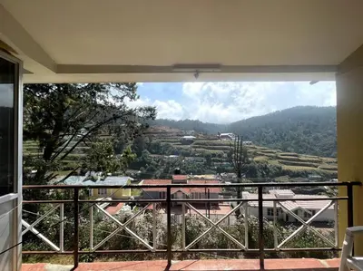 a view of a valley from a balcony of a house at Rustic 3-BR Villa w/ Front & Back Yards in the mountains in Ooty