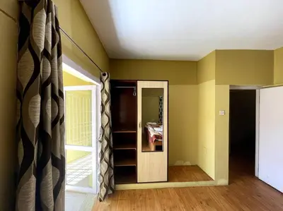 a room with yellow walls and a door with a mirror at Rustic 3-BR Villa w/ Front & Back Yards in the mountains in Ooty