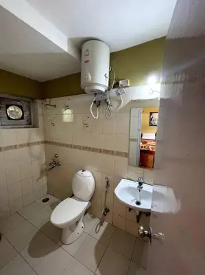 a bathroom with a toilet and a sink at Rustic 3-BR Villa w/ Front & Back Yards in the mountains in Ooty