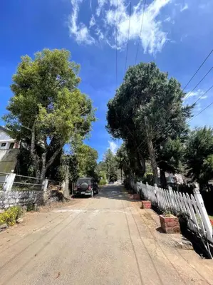 a street with a car parked on the side of the road at Rustic 3-BR Villa w/ Front & Back Yards in the mountains in Ooty