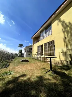 a building with a bird cage in front of it at Rustic 3-BR Villa w/ Front & Back Yards in the mountains in Ooty