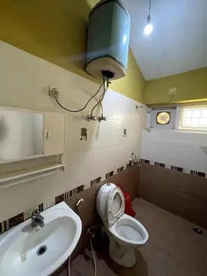 a bathroom with a toilet and a sink at Rustic 3-BR Villa w/ Front & Back Yards in the mountains in Ooty