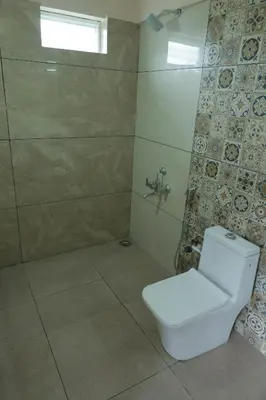 a bathroom with a toilet and a shower at Biosphere in Coonoor