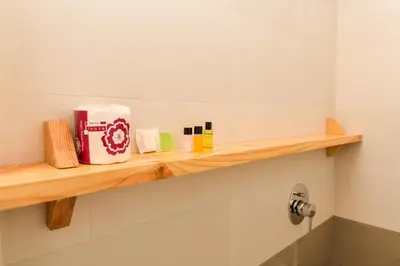 a shelf in a bathroom with a bag on it at Shine Residency in Mysore