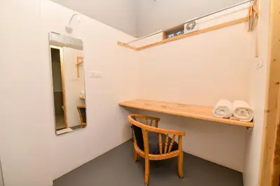 a small room with a wooden desk and a chair at Shine Residency in Mysore