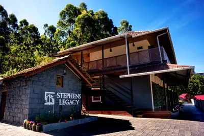 a building with a balcony on the side of it at Stephen's Legacy in Vattavada