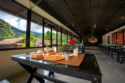 a dining room with a table with food on it at Stephen's Legacy in Vattavada