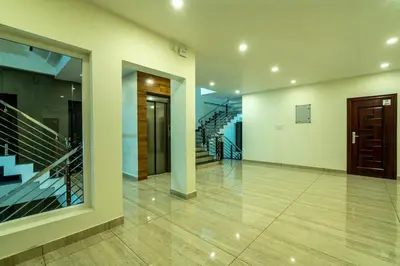 an empty hallway with stairs and a staircase at Daan Regency in Trichūr