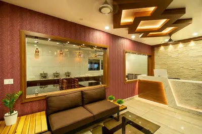 a waiting room with a couch in front of a store at Daan Regency in Trichūr