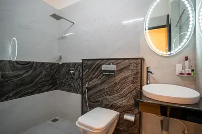 a bathroom with a sink and a toilet and a mirror at Sree Bharat Residency in Alāndurai
